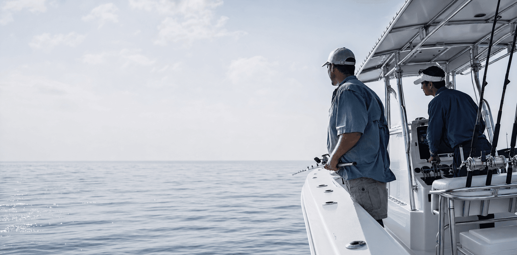 Two crew members aboard a modern fishing and rescue boat at sea